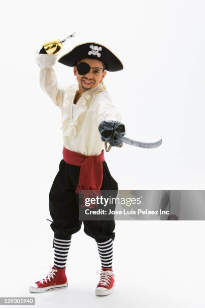 hispanic boy in pirate costume holding sword - pirate stock-fotos und bilder