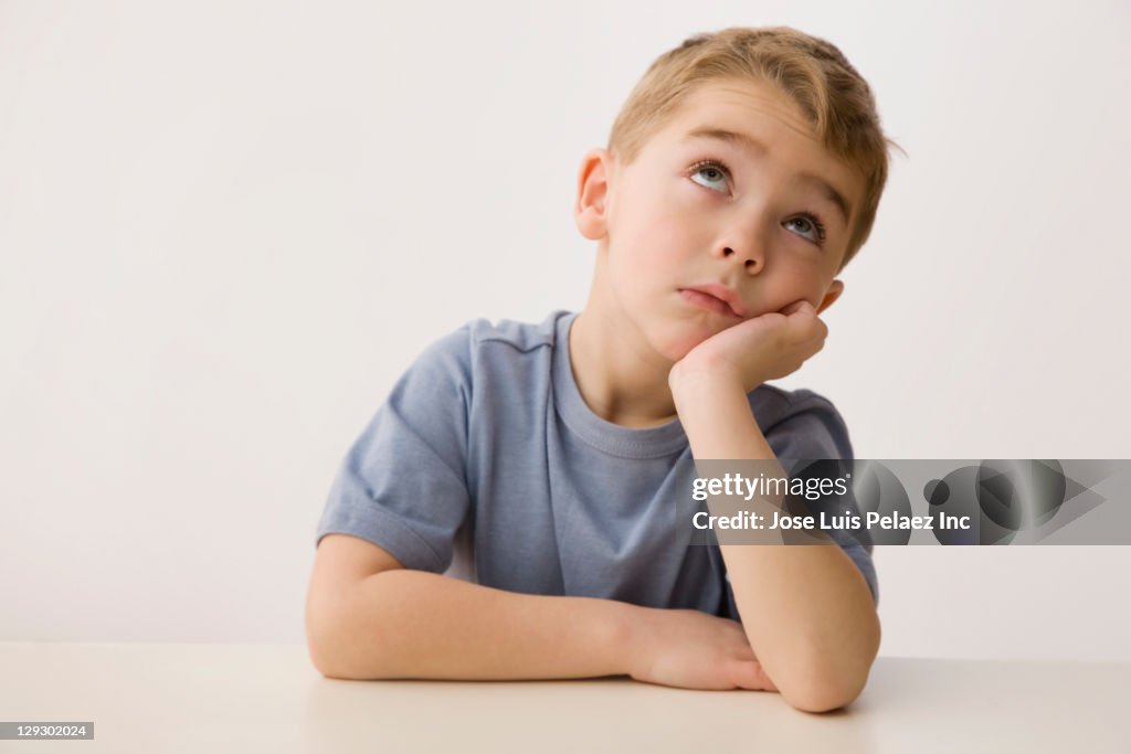 Bored Caucasian boy looking up