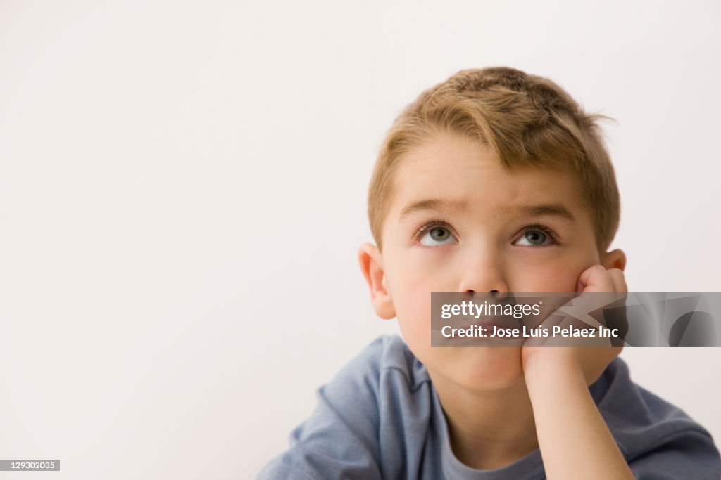 Bored Caucasian boy looking up