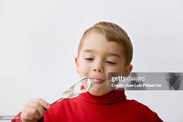 caucasian boy eating batter from beaters - licking lips stock pictures, royalty-free photos & images