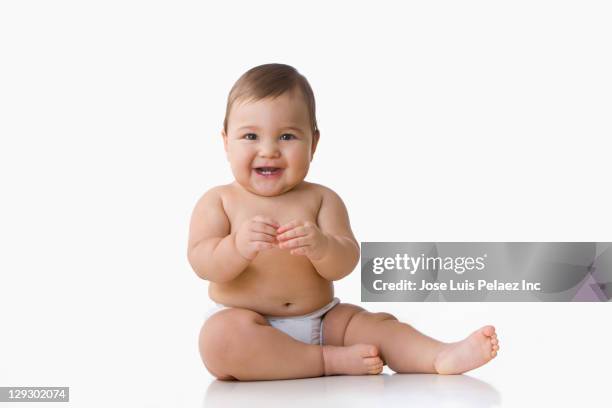 mixed race baby boy sitting on floor - baby isolated stockfoto's en -beelden