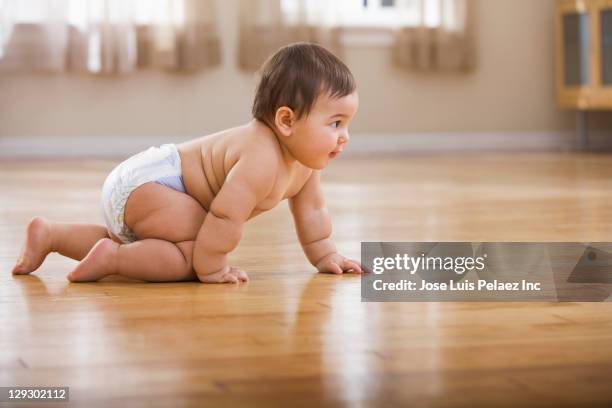 mixed race baby boy crawling on floor - crawling stock pictures, royalty-free photos & images