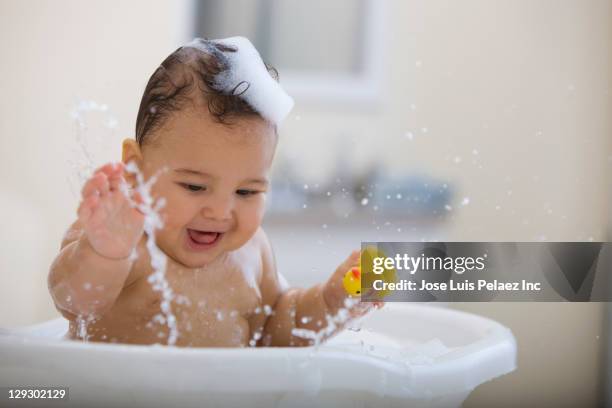 mixed race baby boy having bath - baby bath toys stock pictures, royalty-free photos & images