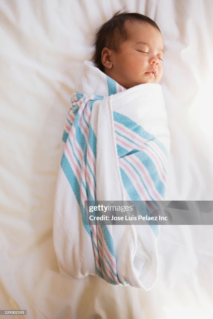 Sleeping newborn mixed race baby girl