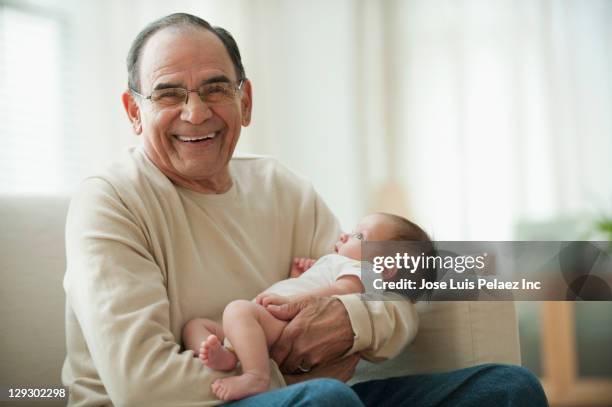 hispanic grandfather holding newborn baby granddaughter - baby grandpa imagens e fotografias de stock