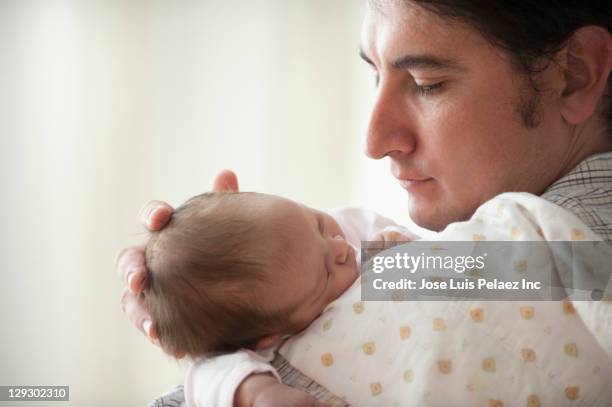 hispanic father holding newborn baby girl - man burping stock pictures, royalty-free photos & images