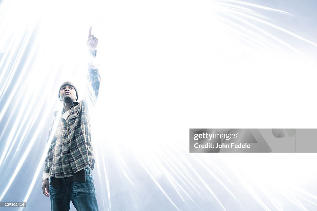 African American man pointing at light spark