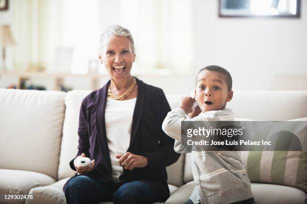 grandmother and grandson playing video game - pre game stockfoto's en -beelden