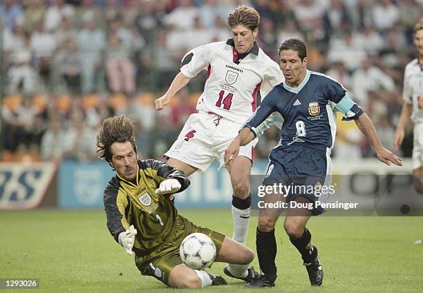 Argentina captain Diego Simeone falls under the challenge of David Seaman of England to win a penalty during the World Cup second round match at the...