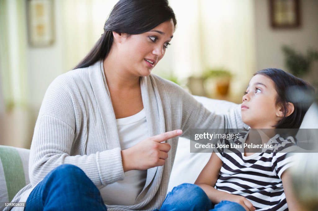 Mixed race mother lecturing daughter