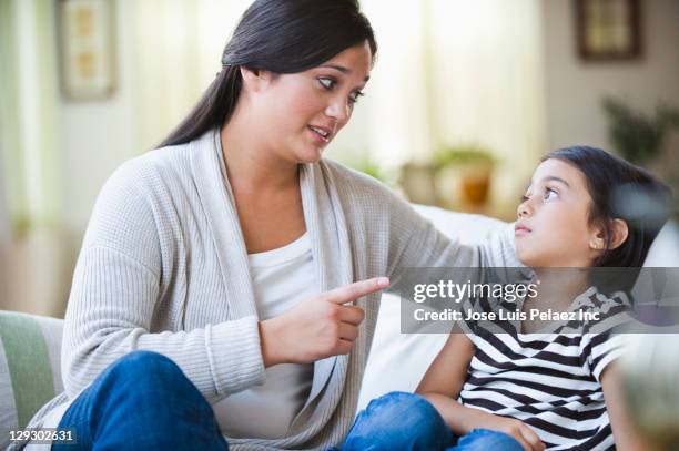 mixed race mother lecturing daughter - mother scolding stock pictures, royalty-free photos & images