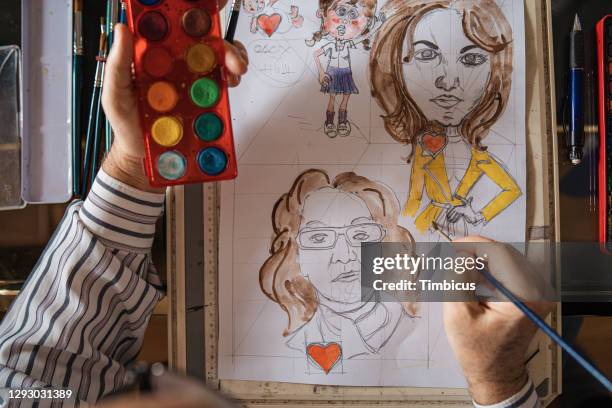 painting caricatures with watercolors - caricature stock pictures, royalty-free photos & images