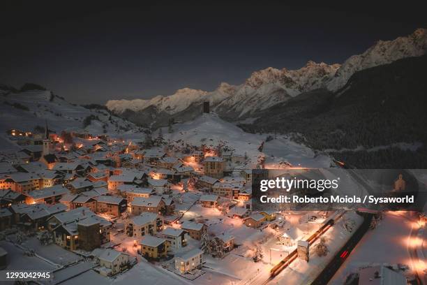 ardez covered with snow in winter, switzerland - aerial train stock pictures, royalty-free photos & images