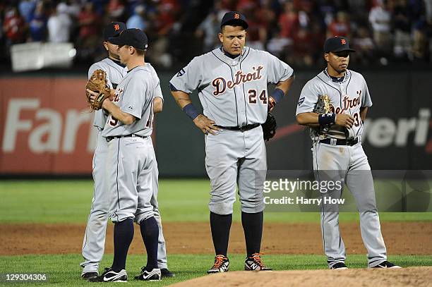 Miguel Cabrera of the Detroit Tigers stands during a pitcher change with Brandon Inge, Jhonny Peralta and Ramon Santiago in the third inning of Game...