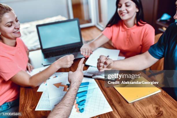 student friends playing rock. paper, scissors to decide who will present project - rock paper scissors stock pictures, royalty-free photos & images