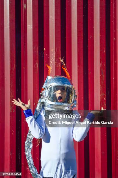 superhero concept. girl with astronaut helmet and raised arms - child in space suit stock pictures, royalty-free photos & images