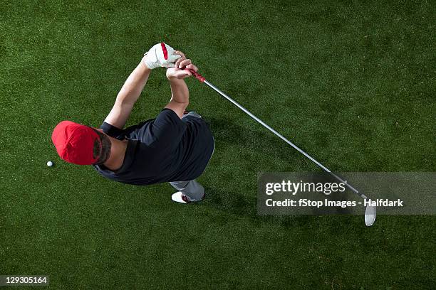 a golfer swinging a golf club, overhead view - golf swing foto e immagini stock
