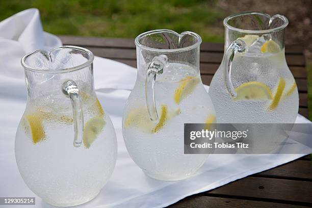 three pitchers of ice water with lemon slices - jug - fotografias e filmes do acervo