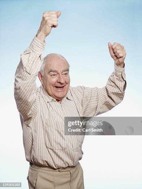 senior man cheering - beige pants stock pictures, royalty-free photos & images