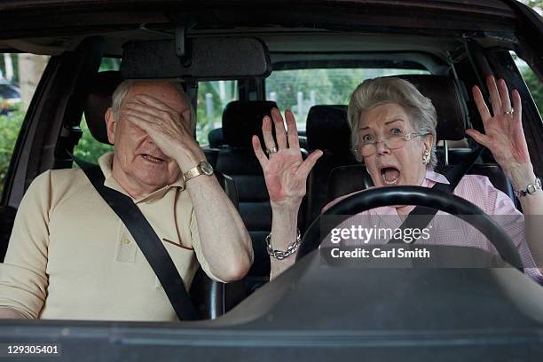 senior woman having trouble learning to drive as man in passenger seat despairs - angry bald screaming man ストックフォトと画像