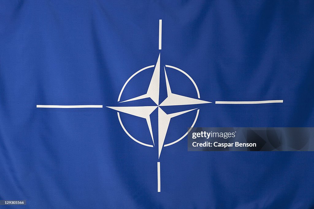 North Atlantic Treaty Organization flag, white compass rose emblem in blue background