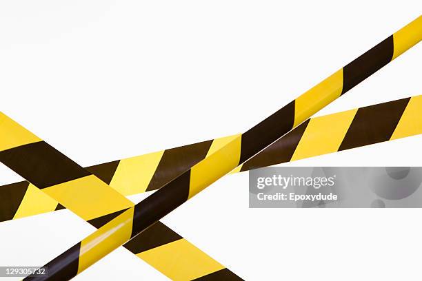 crisscrossed yellow and black striped cordon tape - tape foto e immagini stock