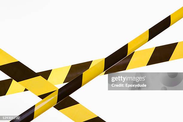 crisscrossed yellow and black striped cordon tape - fita delimitadora imagens e fotografias de stock