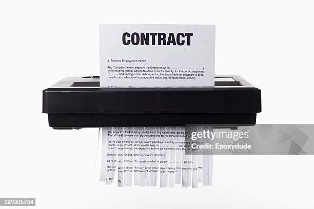 an employment contract being shredded in a paper shredder - paper shredder on white stock pictures, royalty-free photos & images