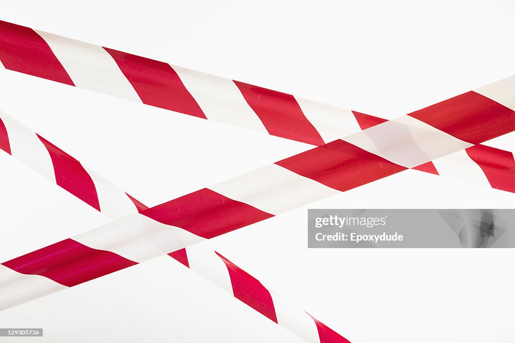 Crisscrossed red and white striped cordon tape 