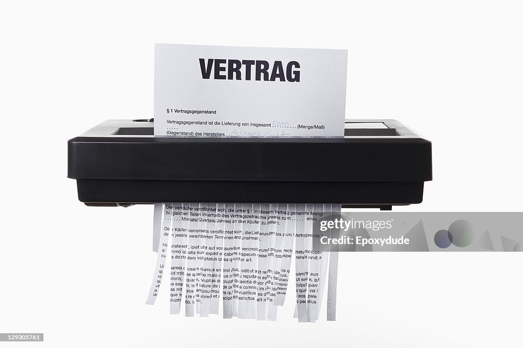 A German employment contract being shredded in a paper shredder