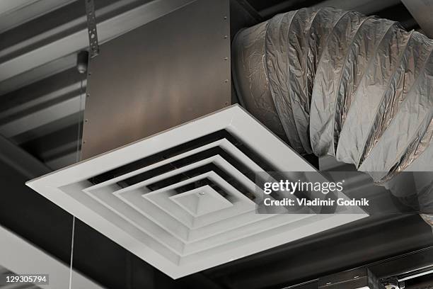 an air duct hanging from a ceiling, close-up, low angle view - air vent stock-fotos und bilder