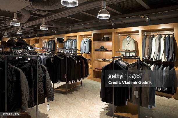 racks of clothes in a menswear store - menswear foto e immagini stock