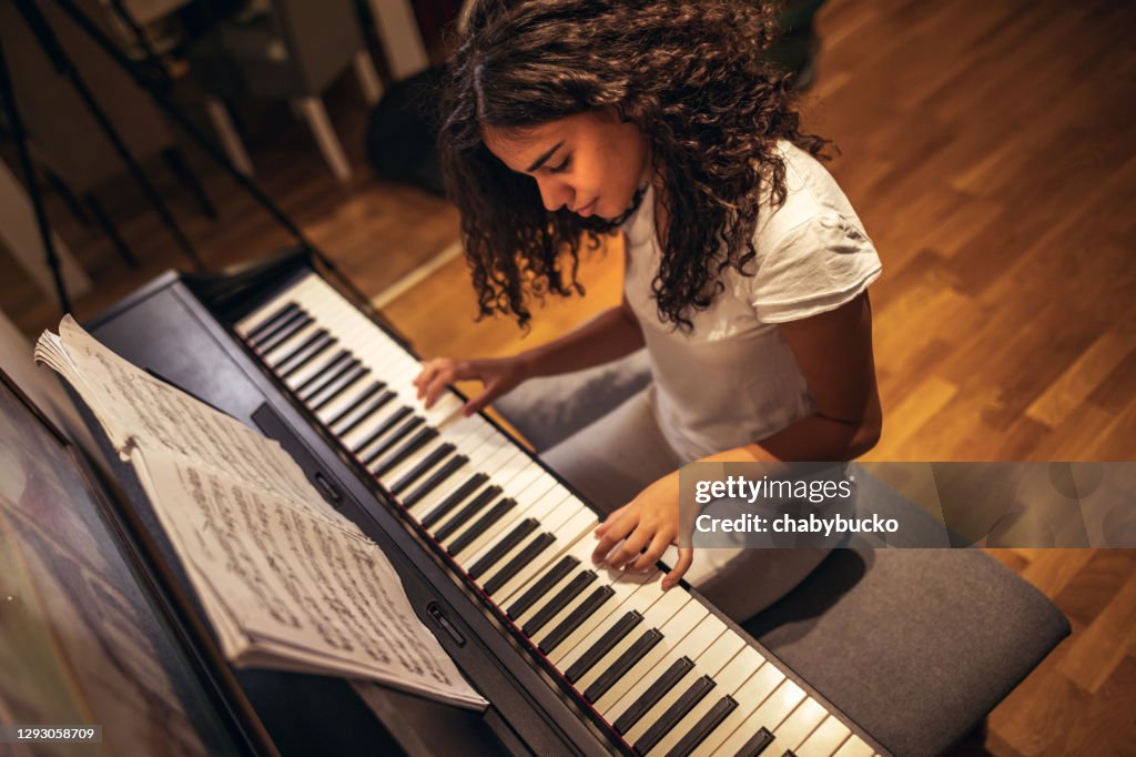Girl playing piano at home