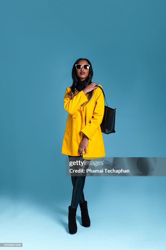 Fashionable woman in a yellow coat