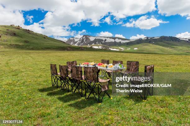 pinic table at a camping site, eki naryn gorge, naryn region, central tian shan mountains, kyrgyzstan - camping chair stock pictures, royalty-free photos & images