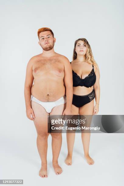 young couple wearing underwear, full length - chubby men stock-fotos und bilder