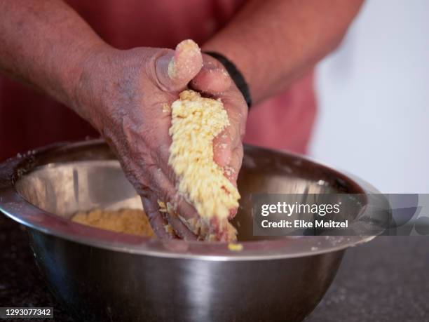 man mixing ingredients for cake - melbourne lockdown stock pictures, royalty-free photos & images