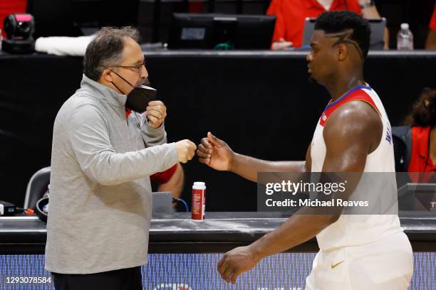 Head coach Stan Van Gundy of the New Orleans Pelicans fist bumps Zion Williamson against the Miami Heat during the third quarter at American Airlines...