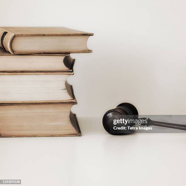 judges gavel beside stacked law books - law school stock pictures, royalty-free photos & images