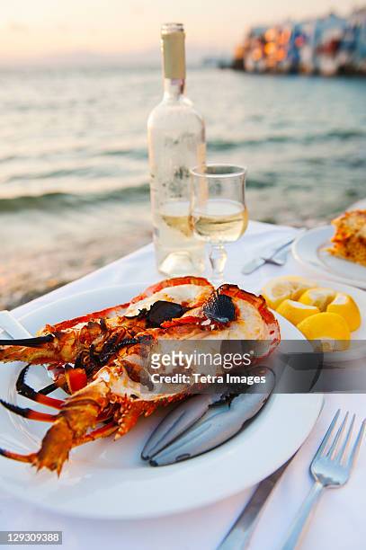 greece, cyclades islands, mykonos, lobser dinner at coast - greece food stock pictures, royalty-free photos & images