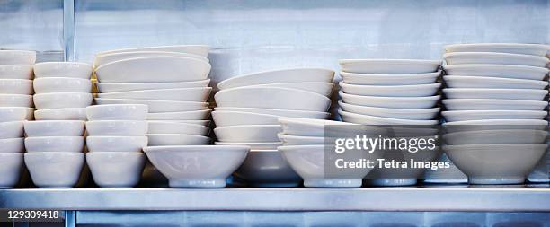 usa, new york, new york city, stacked plates and bowls in kitchen - stack of plates stock pictures, royalty-free photos & images