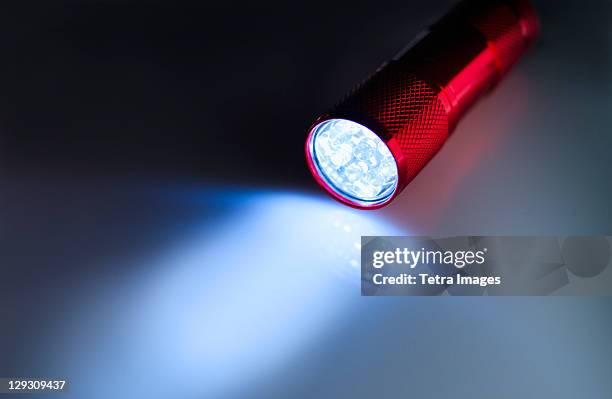 illuminated flashlight - flashlight stockfoto's en -beelden