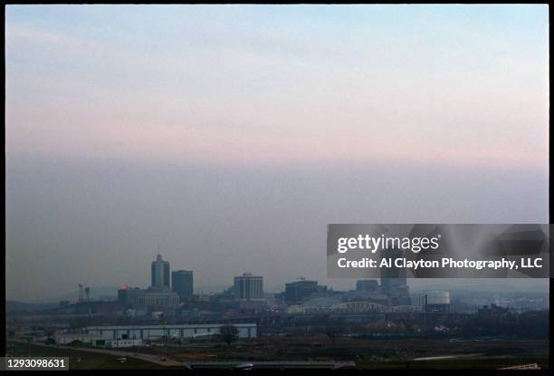 City of Nashville, Tennessee skyline where the Cumberland river separates downtown Nashville from East Nashville. Shot at sunrise in 1969. Photo is...