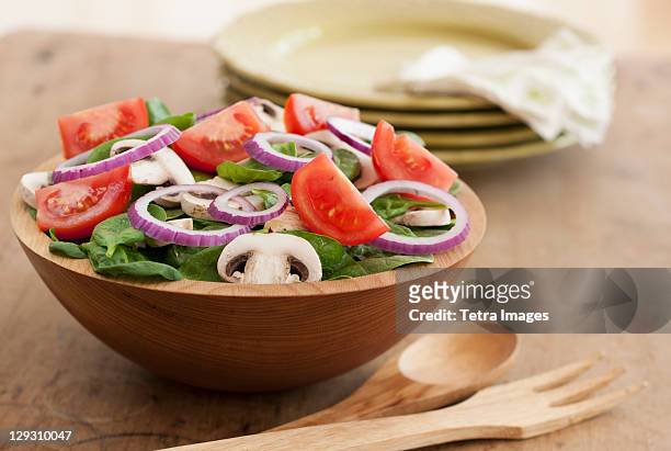 fresh salad in bowl on table - salad bowl stock pictures, royalty-free photos & images