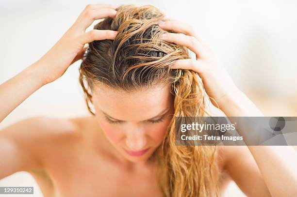 usa, new jersey, jersey city, woman washing hair - blonde hair roots stock pictures, royalty-free photos & images