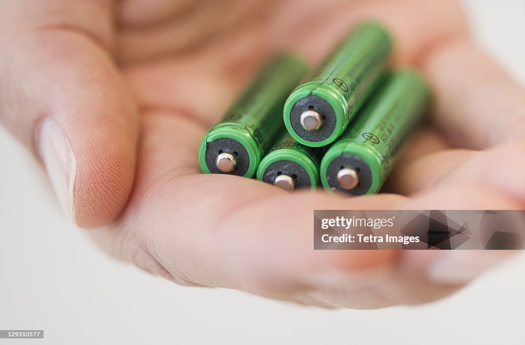 Hand holding batteries