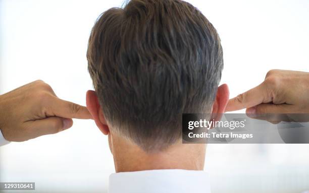 usa, new jersey, jersey city, businessman plugging ears - vingers in de oren stockfoto's en -beelden