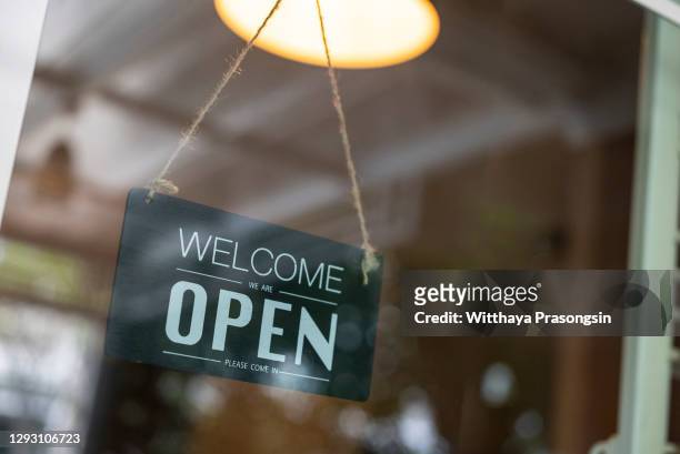 store open sign hanging on the window - open sign on door stock-fotos und bilder