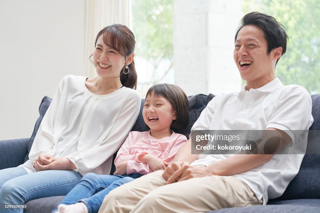 Asian family smiling on the sofa