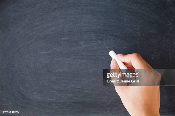 usa, new jersey, jersey city, close up of woman's hands writing with chalk on blackboard - chalk hands stock pictures, royalty-free photos & images